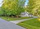 Charming home with a well-manicured front yard and long driveway surrounded by mature trees offering curb appeal at 2616 Dockery Ln, Raleigh, NC 27606