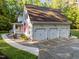 Spacious three-car garage attached to a charming home with well-manicured landscaping at 2616 Dockery Ln, Raleigh, NC 27606