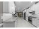 Spacious kitchen boasting white cabinets, granite countertops, stainless appliances, and tile floors at 2616 Dockery Ln, Raleigh, NC 27606