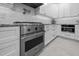 Kitchen featuring stainless steel Viking oven, subway tile backsplash, granite countertops, and white cabinets at 2616 Dockery Ln, Raleigh, NC 27606