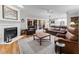 Inviting living room features a fireplace, hardwood floors, and comfortable leather furniture at 2616 Dockery Ln, Raleigh, NC 27606