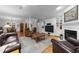 Spacious living room with a fireplace, built-in shelves, hardwood floors, and open to dining area at 2616 Dockery Ln, Raleigh, NC 27606