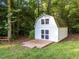 Storage shed in the backyard with platform deck, great for outdoor tools or hobbies, set among mature trees at 2616 Dockery Ln, Raleigh, NC 27606