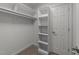 The walk-in closet has carpet, shelving and a hanging rail for storage at 2616 Dockery Ln, Raleigh, NC 27606