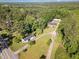 An aerial view of a wooded property featuring multiple structures and a winding driveway at 2670 Nc 210 S, Lillington, NC 27546