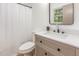 Stylish bathroom with a modern vanity, framed mirror, and shower-tub combination at 2670 Nc 210 S, Lillington, NC 27546