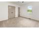 Bright bedroom featuring neutral carpet, gray closet doors, and a window with an outside view at 2670 Nc 210 S, Lillington, NC 27546