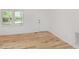 Bright entryway with new wood flooring, a white door, and a double window at 2670 Nc 210 S, Lillington, NC 27546