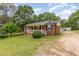 Quaint brick home with a welcoming front porch and well-maintained lawn at 2670 Nc 210 S, Lillington, NC 27546
