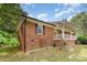 Charming brick home with dark shutters, inviting front porch and manicured lawn at 2670 Nc 210 S, Lillington, NC 27546