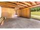Spacious garage features unfinished walls, concrete floor, and an open view to the yard at 2670 Nc 210 S, Lillington, NC 27546