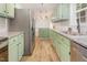 Updated kitchen with granite counters, stainless steel appliances, and mint green cabinets at 2670 Nc 210 S, Lillington, NC 27546