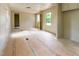Bright living room with unfinished flooring, large windows, and light neutral paint at 2670 Nc 210 S, Lillington, NC 27546