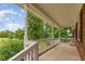 Inviting covered front porch with white railings and view of landscaped yard at 2670 Nc 210 S, Lillington, NC 27546