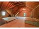Unfinished attic space with exposed wooden beams, framing, and a window at the far end at 2720 Snowy Meadow Ct, Raleigh, NC 27614