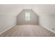 Carpeted attic bonus room with dormer windows provides extra living space in a neutral color palette at 2720 Snowy Meadow Ct, Raleigh, NC 27614