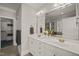 Elegant bathroom featuring a double sink vanity, large mirror, and walk-in closet access at 2720 Snowy Meadow Ct, Raleigh, NC 27614
