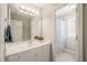 Bathroom vanity with large mirror and shower/tub combo in an adjacent room at 2720 Snowy Meadow Ct, Raleigh, NC 27614