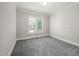 This is a bedroom featuring a window, grey carpet, and white trim at 2720 Snowy Meadow Ct, Raleigh, NC 27614