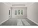 Comfortable bedroom featuring plush carpeting and large window allowing for ample natural light at 2720 Snowy Meadow Ct, Raleigh, NC 27614