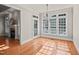 Bright dining area with hardwood floors, large windows, and an elegant chandelier at 2720 Snowy Meadow Ct, Raleigh, NC 27614