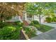 Inviting entrance to a home featuring a quaint front porch with white railings and lush landscaping at 2720 Snowy Meadow Ct, Raleigh, NC 27614