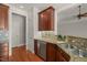 Kitchen area featuring rich wooden cabinetry, granite countertops, and stainless steel appliances at 2720 Snowy Meadow Ct, Raleigh, NC 27614