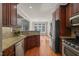 Modern kitchen showcasing granite countertops, stainless steel appliances, and rich wooden cabinets at 2720 Snowy Meadow Ct, Raleigh, NC 27614