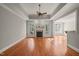 Bright living room with a cozy fireplace, hardwood floors, and large windows at 2720 Snowy Meadow Ct, Raleigh, NC 27614
