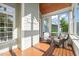 Relax on this charming screened porch with natural wood floors and comfortable wicker seating at 2720 Snowy Meadow Ct, Raleigh, NC 27614