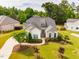 Aerial view of a home with beautiful landscaping, a healthy lawn, and a gray roof at 2910 Reynolda Cir, Durham, NC 27712
