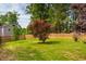 A well-maintained backyard with lush green grass and a wooden privacy fence at 2910 Reynolda Cir, Durham, NC 27712