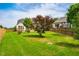 A spacious backyard featuring green grass, mature trees, and a wood fence at 2910 Reynolda Cir, Durham, NC 27712