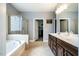 This bathroom features double vanity, soaking tub, glass enclosed shower and walk in closet at 2910 Reynolda Cir, Durham, NC 27712