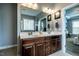 Spacious bathroom with double vanity, granite countertop, large mirror, and decorative lighting at 2910 Reynolda Cir, Durham, NC 27712