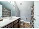 Bathroom features a dark vanity with a sink, a toilet, and shower with animal-themed curtain at 2910 Reynolda Cir, Durham, NC 27712