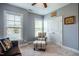 Bedroom features a comfortable chair and ottoman, with large windows and closet space at 2910 Reynolda Cir, Durham, NC 27712