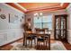 Elegant dining area with tray ceiling, natural light, stylish rug, and classic hutch at 2910 Reynolda Cir, Durham, NC 27712
