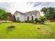 Beautiful front yard with lush lawn and landscaped flower beds around the home at 2910 Reynolda Cir, Durham, NC 27712
