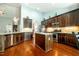 Spacious kitchen features stainless appliances, granite countertops, island, and hardwood floors at 2910 Reynolda Cir, Durham, NC 27712