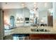 Open-concept kitchen with granite counters, island with sink, and stylish pendant lighting at 2910 Reynolda Cir, Durham, NC 27712