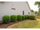 A well-manicured side yard with neatly trimmed bushes and mulch beds at 2910 Reynolda Cir, Durham, NC 27712