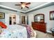 Bright main bedroom features neutral walls, ceiling fan, trey ceiling and large dresser with mirror at 2910 Reynolda Cir, Durham, NC 27712