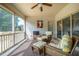 Inviting screened porch features comfortable wicker seating and a ceiling fan for relaxation at 2910 Reynolda Cir, Durham, NC 27712