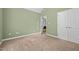 A carpeted bedroom with an open doorway showing an additional room and white trim on the door frames at 2917 Kesler Trl, Mebane, NC 27302