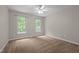 Bedroom with carpeted floors, a ceiling fan, and natural light from the two windows at 2917 Kesler Trl, Mebane, NC 27302