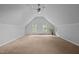 An expansive bonus room with carpeted floors, natural light from two windows and neutral wall colors at 2917 Kesler Trl, Mebane, NC 27302