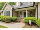 Charming covered front porch with rocking chair and manicured landscaping at 2917 Kesler Trl, Mebane, NC 27302