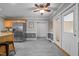 Spacious kitchen with stainless steel appliances and tile flooring leads to white French doors at 2917 Kesler Trl, Mebane, NC 27302