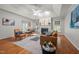 Open concept living room with hardwood floors, fireplace, tray ceiling, and access to other rooms at 2917 Kesler Trl, Mebane, NC 27302